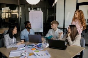 A diverse team discussing business strategy around a conference table in a modern office.